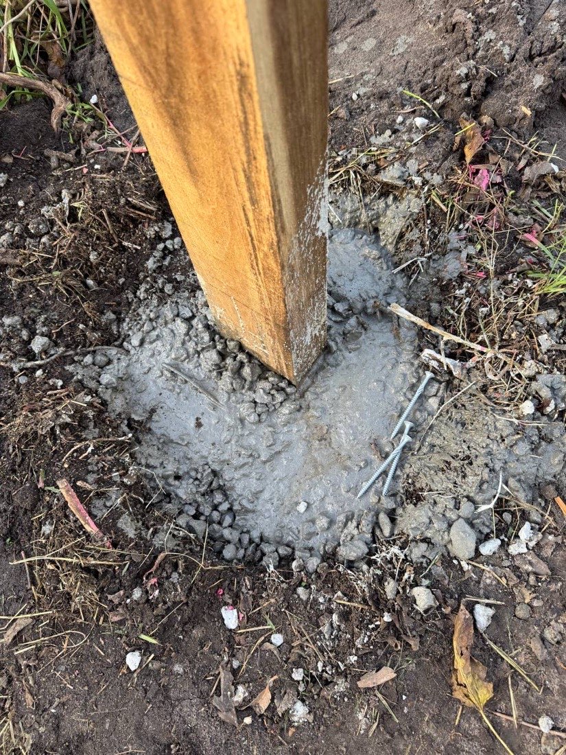 Hardwood fence post set in a freshly poured concrete footing by Drysdale Fencing in Geelong